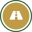 A white icon of a road inside a gold circle which has a white and a green stroke.